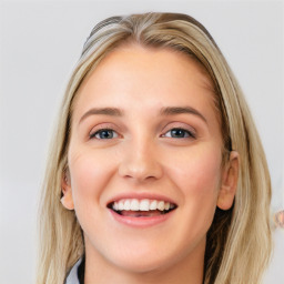 Joyful white young-adult female with long  brown hair and blue eyes