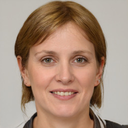 Joyful white adult female with medium  brown hair and grey eyes