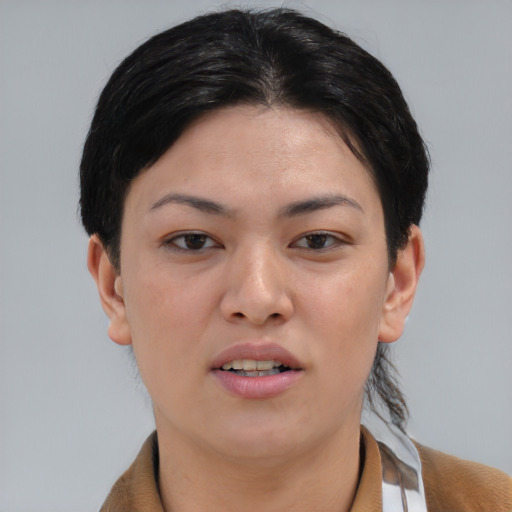Joyful asian young-adult female with short  brown hair and brown eyes
