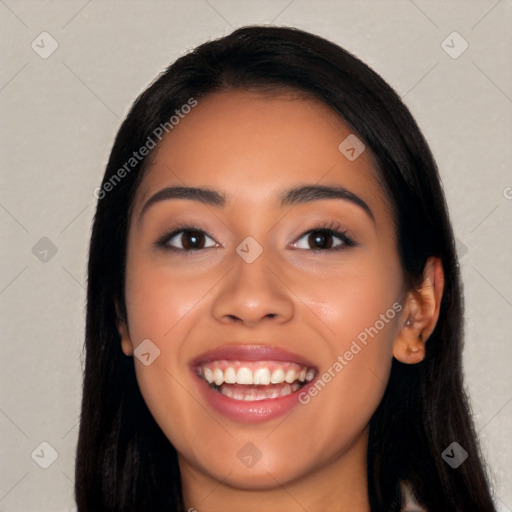 Joyful latino young-adult female with long  black hair and brown eyes