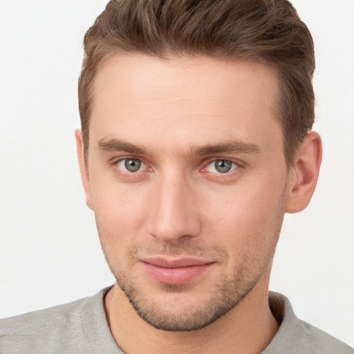 Joyful white young-adult male with short  brown hair and grey eyes