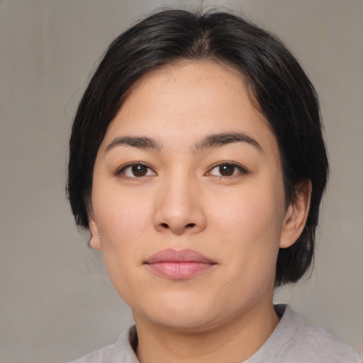 Joyful asian young-adult female with medium  black hair and brown eyes