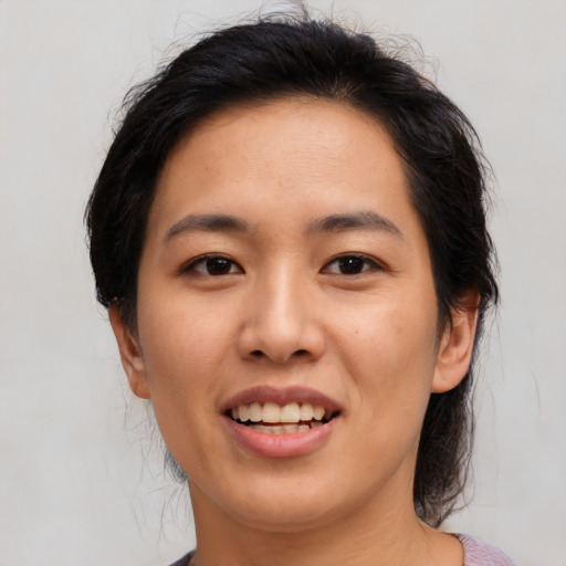 Joyful asian young-adult female with medium  black hair and brown eyes