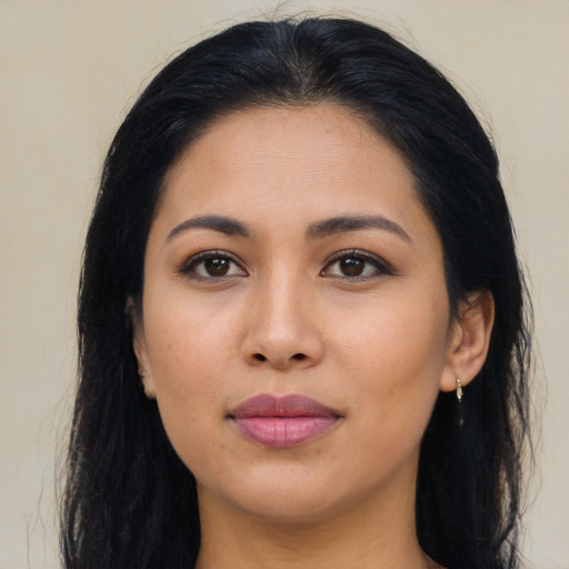 Joyful latino young-adult female with long  brown hair and brown eyes