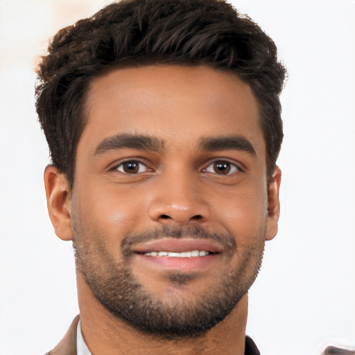 Joyful black young-adult male with short  black hair and brown eyes