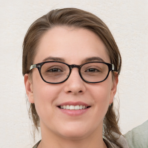 Joyful white young-adult female with medium  brown hair and blue eyes