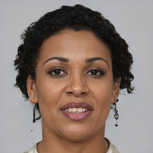 Joyful black adult female with short  brown hair and brown eyes