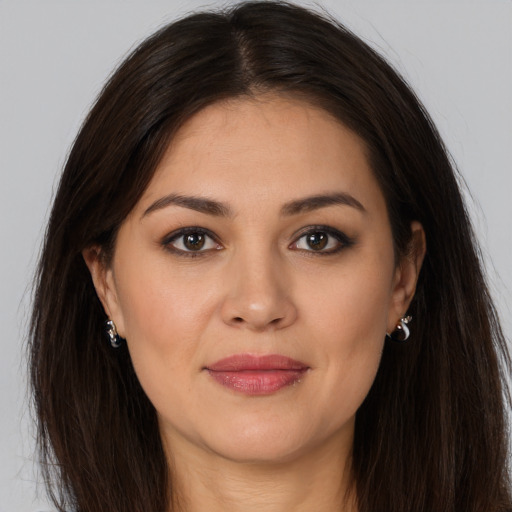 Joyful white young-adult female with long  brown hair and brown eyes