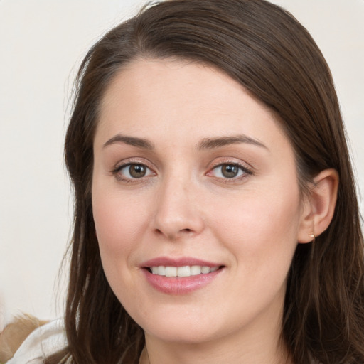 Joyful white young-adult female with long  brown hair and grey eyes