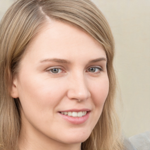 Joyful white young-adult female with long  brown hair and grey eyes