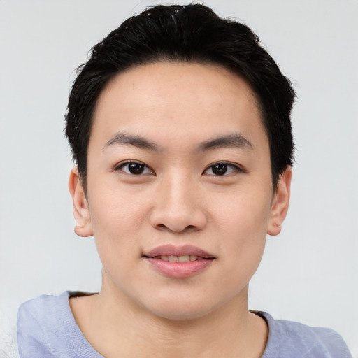 Joyful asian young-adult male with short  black hair and brown eyes