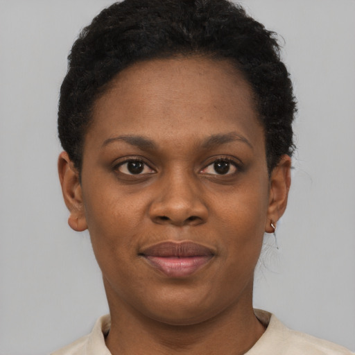Joyful black young-adult female with short  brown hair and brown eyes