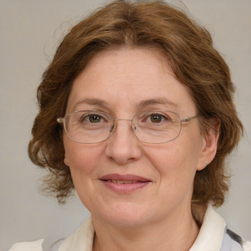 Joyful white middle-aged female with medium  brown hair and green eyes