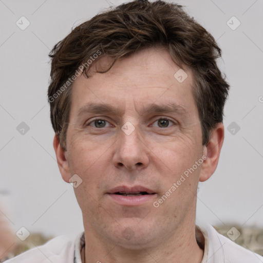 Joyful white adult male with short  brown hair and grey eyes