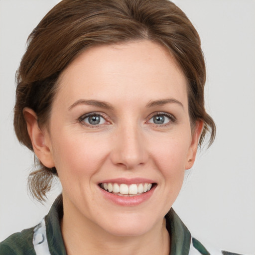 Joyful white young-adult female with medium  brown hair and blue eyes