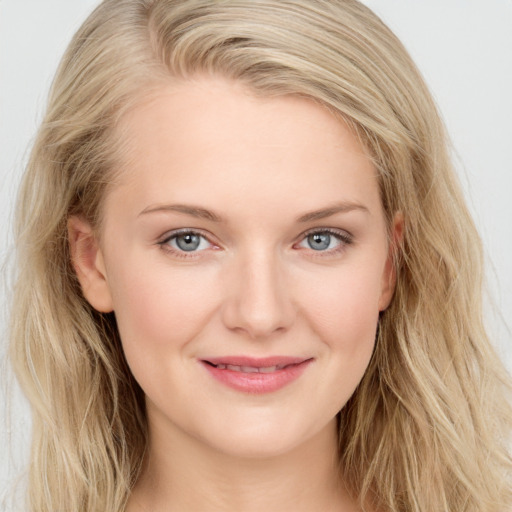 Joyful white young-adult female with long  brown hair and blue eyes