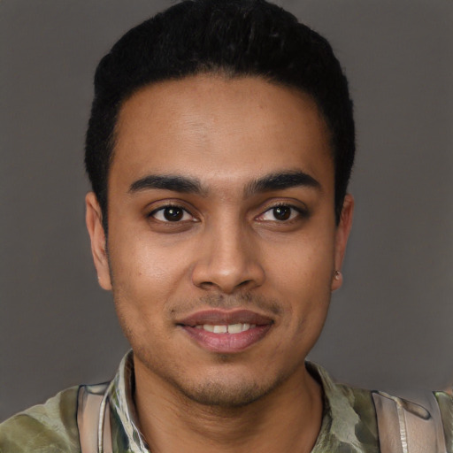 Joyful latino young-adult male with short  black hair and brown eyes