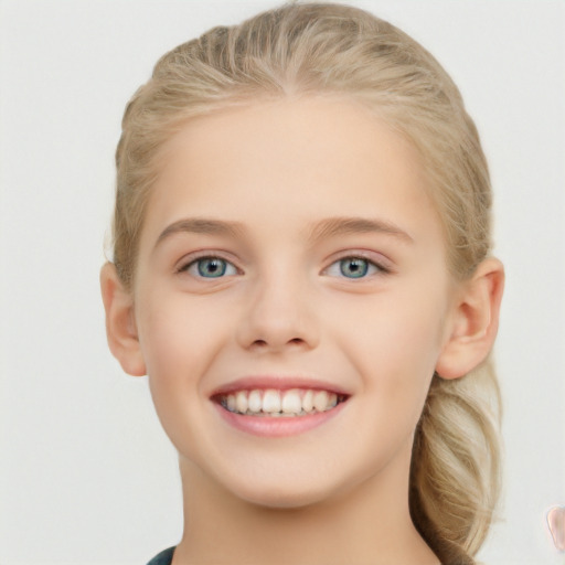 Joyful white child female with short  brown hair and blue eyes