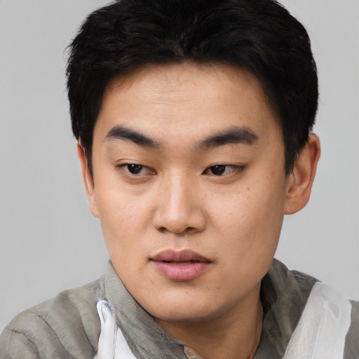 Neutral asian young-adult male with short  brown hair and brown eyes