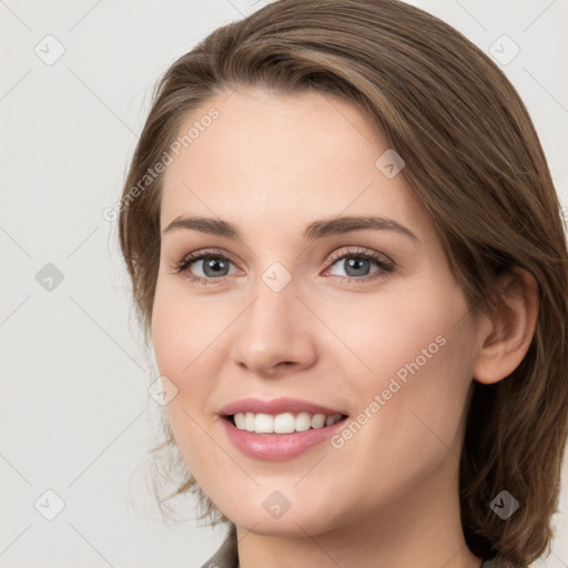 Joyful white young-adult female with medium  brown hair and green eyes