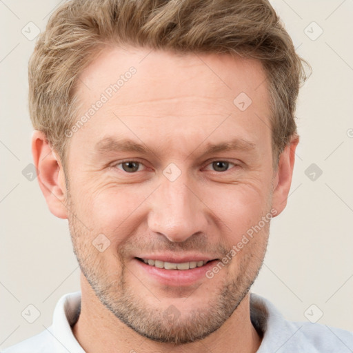 Joyful white adult male with short  brown hair and grey eyes