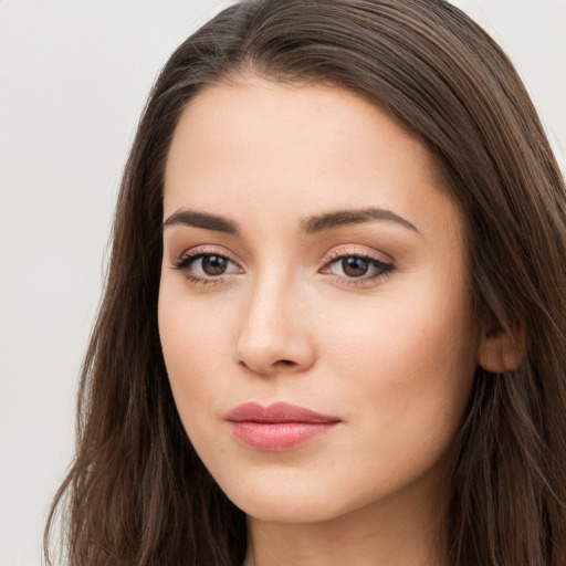 Neutral white young-adult female with long  brown hair and brown eyes