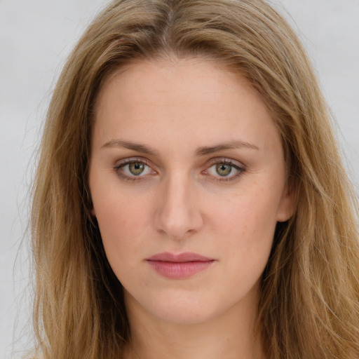 Joyful white young-adult female with long  brown hair and green eyes