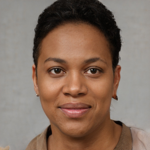 Joyful black young-adult female with short  brown hair and brown eyes