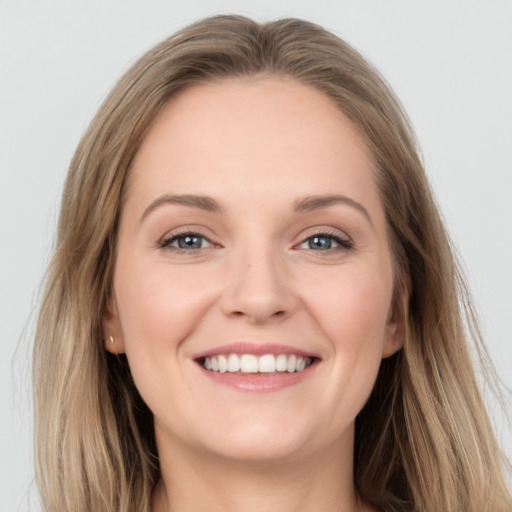 Joyful white young-adult female with long  brown hair and grey eyes