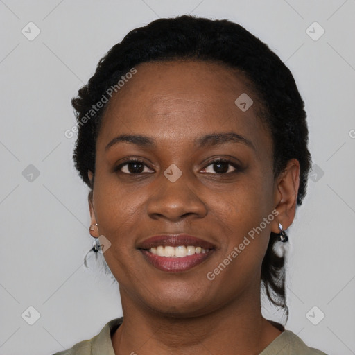 Joyful black young-adult female with short  black hair and brown eyes