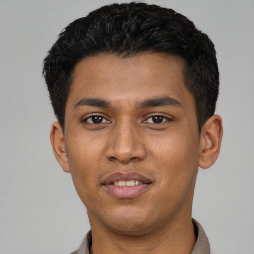Joyful latino young-adult male with short  black hair and brown eyes
