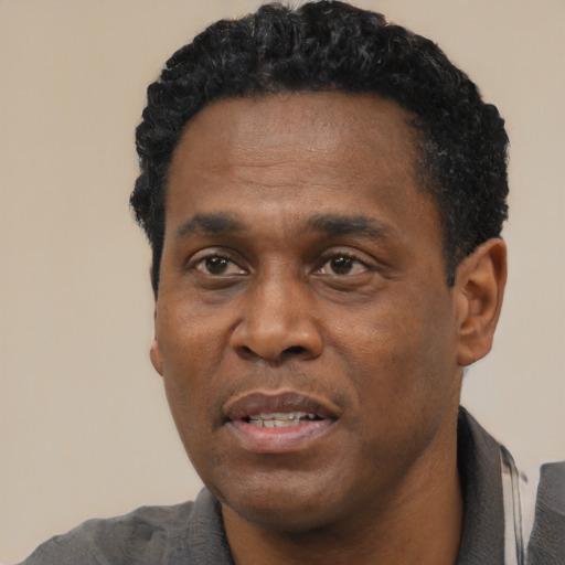 Neutral black adult male with short  black hair and brown eyes