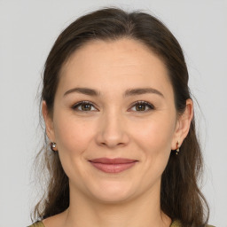 Joyful white young-adult female with medium  brown hair and brown eyes