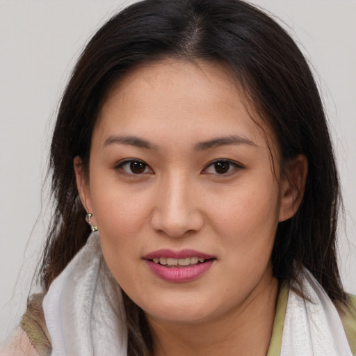 Joyful white young-adult female with long  brown hair and brown eyes