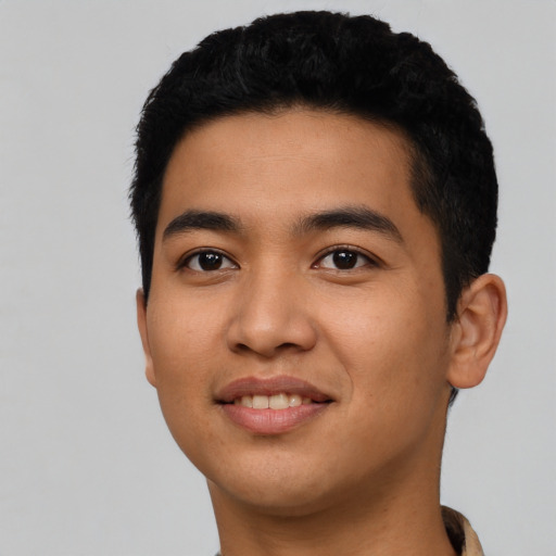 Joyful latino young-adult male with short  black hair and brown eyes