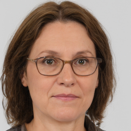 Joyful white middle-aged female with medium  brown hair and brown eyes