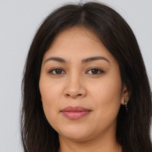 Joyful latino young-adult female with long  brown hair and brown eyes