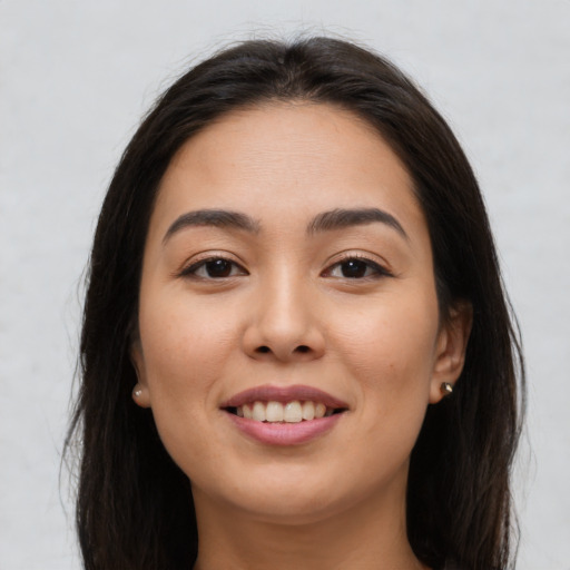 Joyful asian young-adult female with long  brown hair and brown eyes