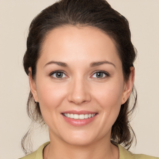 Joyful white young-adult female with medium  brown hair and brown eyes