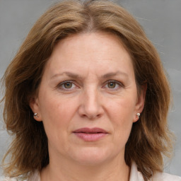 Joyful white adult female with medium  brown hair and grey eyes