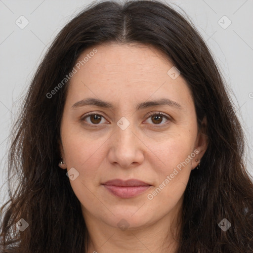 Joyful white adult female with long  brown hair and brown eyes