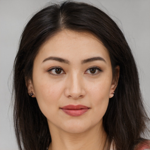 Joyful asian young-adult female with long  brown hair and brown eyes