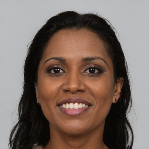 Joyful latino young-adult female with long  brown hair and brown eyes