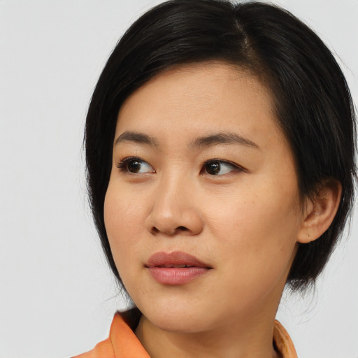 Joyful asian young-adult female with medium  black hair and brown eyes