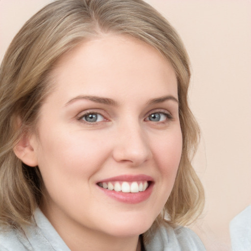 Joyful white young-adult female with medium  brown hair and blue eyes