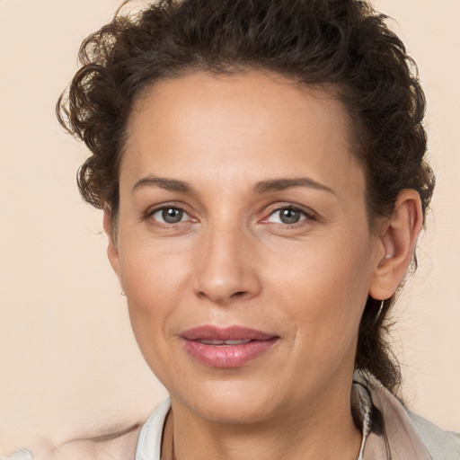 Joyful white adult female with short  brown hair and brown eyes