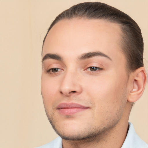 Joyful white young-adult male with short  brown hair and brown eyes