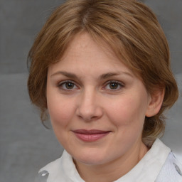 Joyful white adult female with medium  brown hair and blue eyes