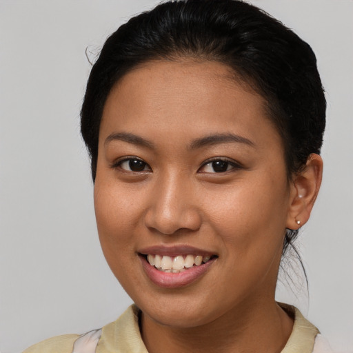 Joyful asian young-adult female with short  brown hair and brown eyes