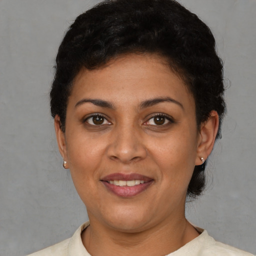 Joyful latino young-adult female with short  brown hair and brown eyes